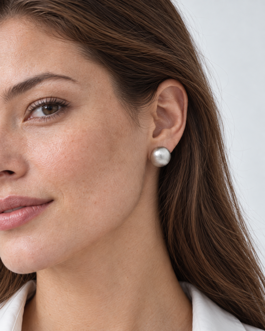 Silver earrings worn by the model